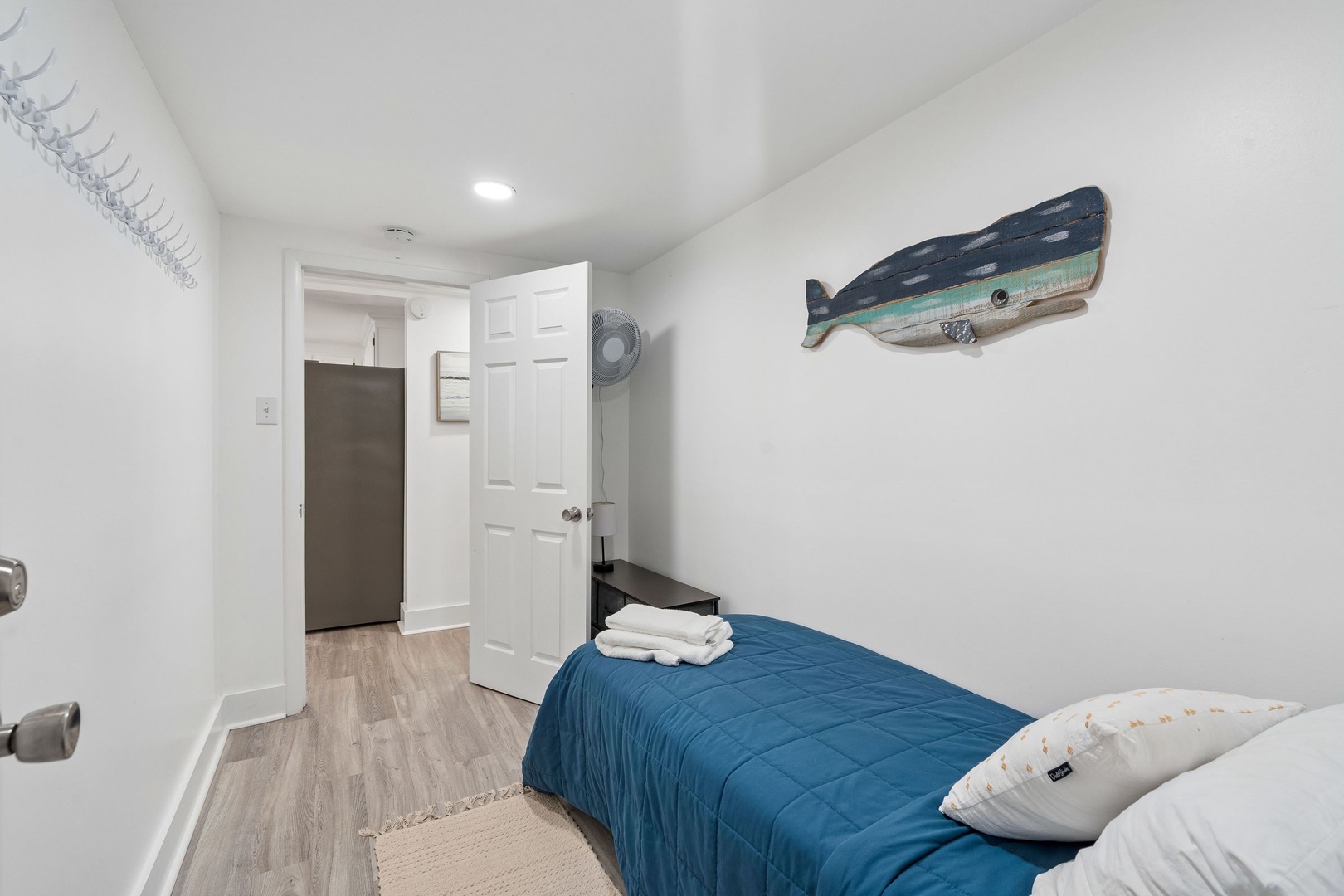Drift off in this cozy coastal bedroom where nautical artwork and soft blue linens create your perfect seaside retreat.