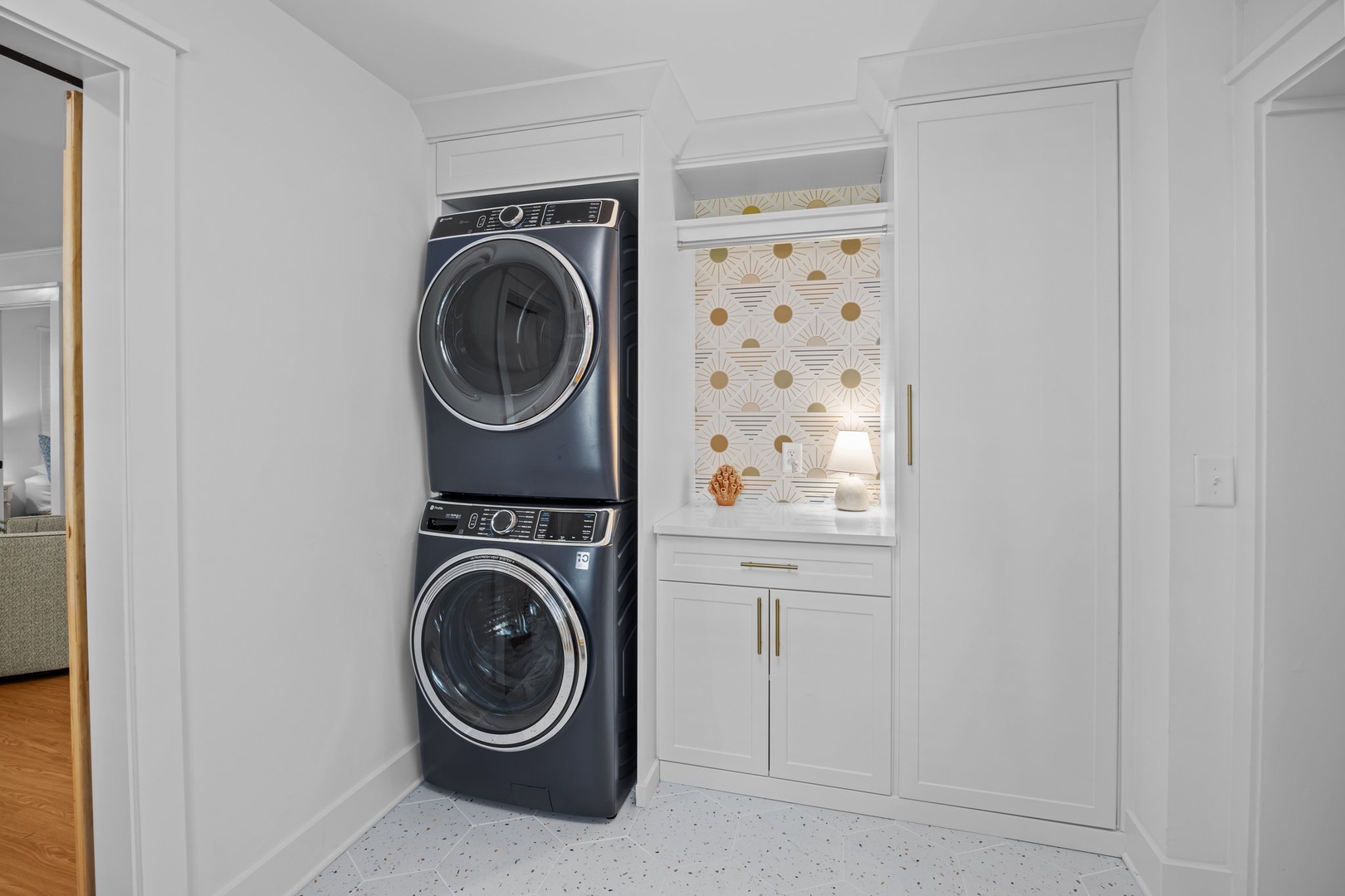 Your private laundry nook features stacked washer-dryer with elegant built-in storage, making vacation maintenance effortless and stylish.