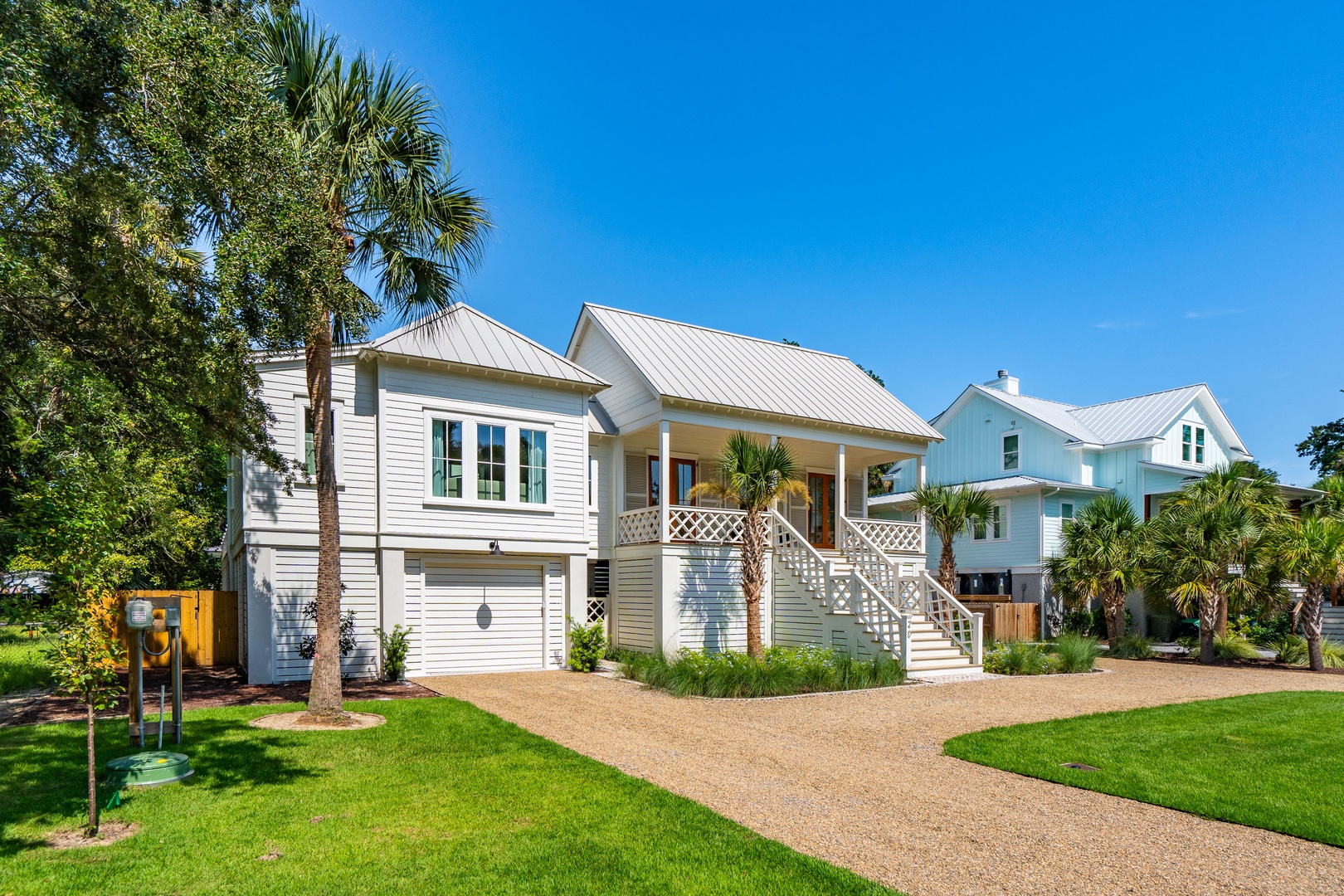 This coastal-style rental welcomes you with charming architectural details, lush landscaping, and plenty of Southern sunshine. Located in a peaceful neighborhood with established palms and trees.