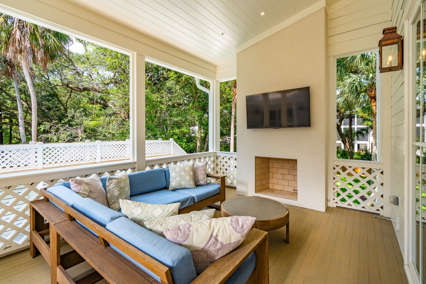 Settle into your private screened porch with cozy seating and a fireplace—perfect for breezy evenings surrounded by lush greenery and the soft glow of lantern light.