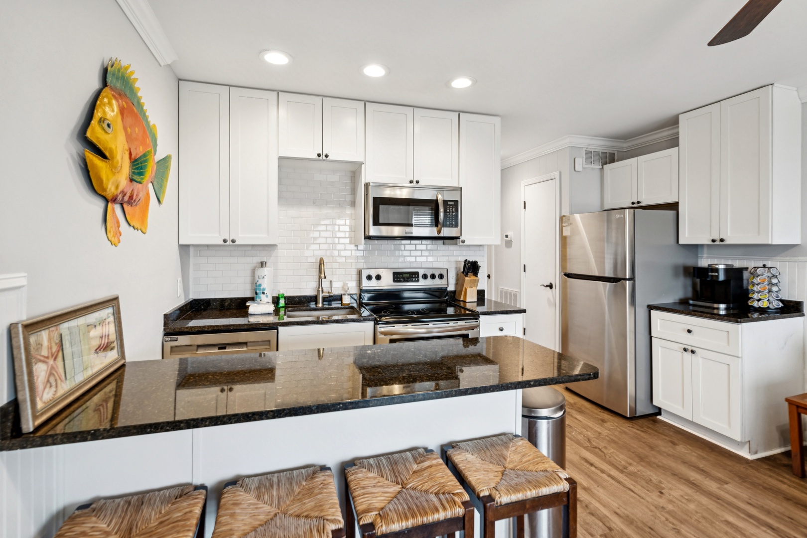 Your fully-equipped kitchen features granite counters, stainless appliances, and a breakfast bar for morning coffee or evening cocktails.