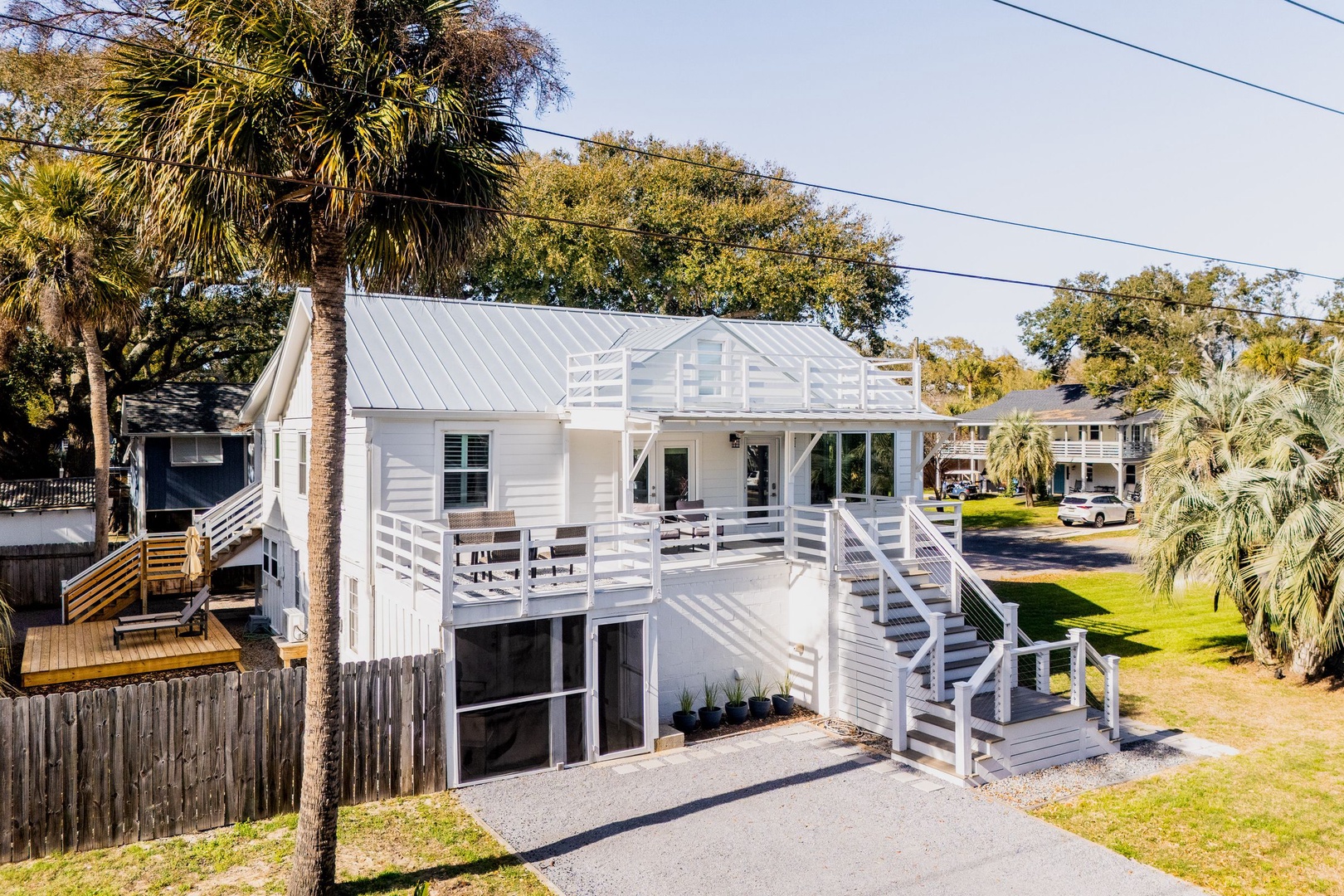 Modern coastal retreat with tropical landscaping and convenient parking in a peaceful neighborhood setting.