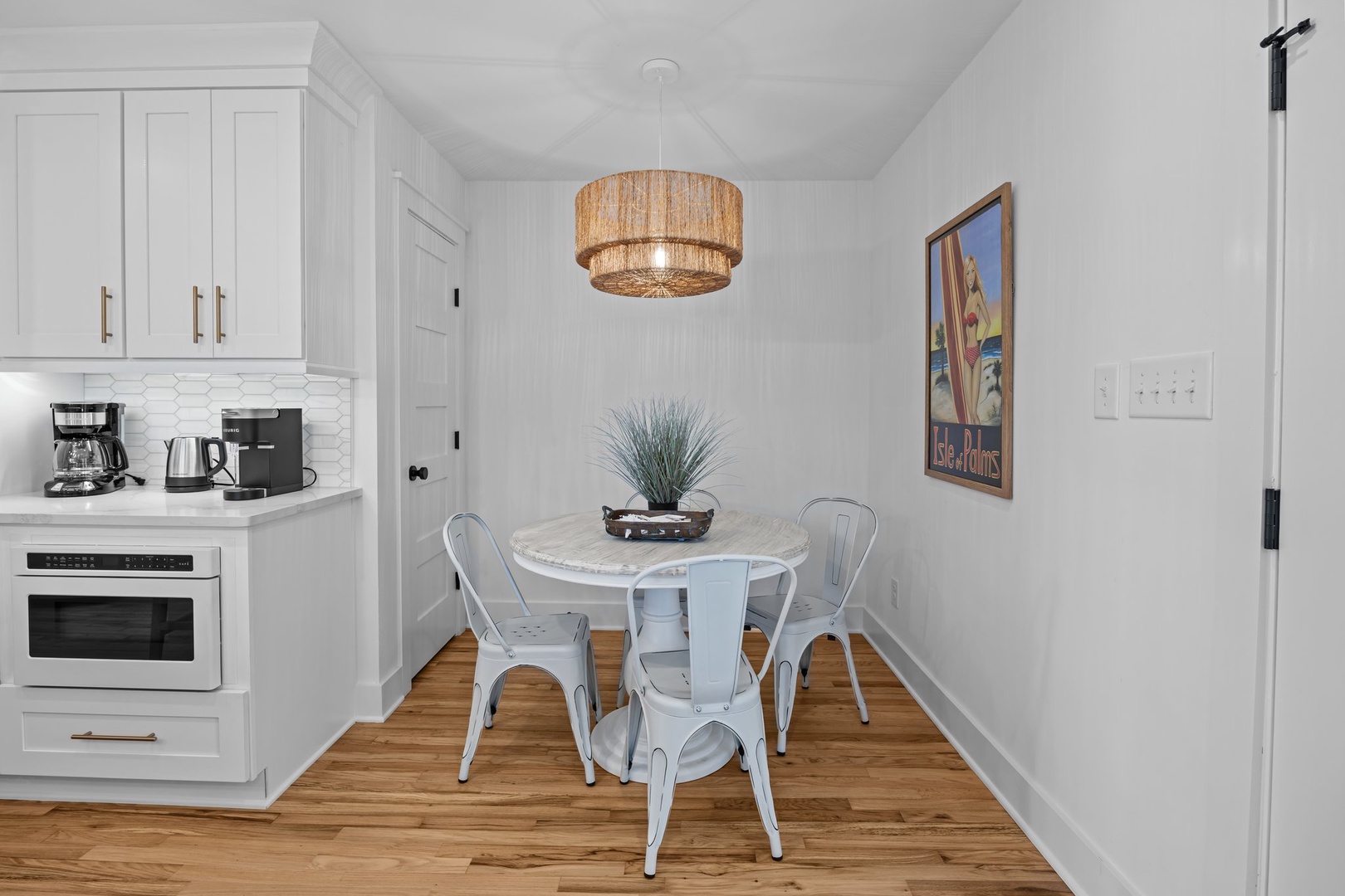 Your bright dining nook features a cozy table for four under warm pendant lighting, perfect for morning coffee or intimate meals together.