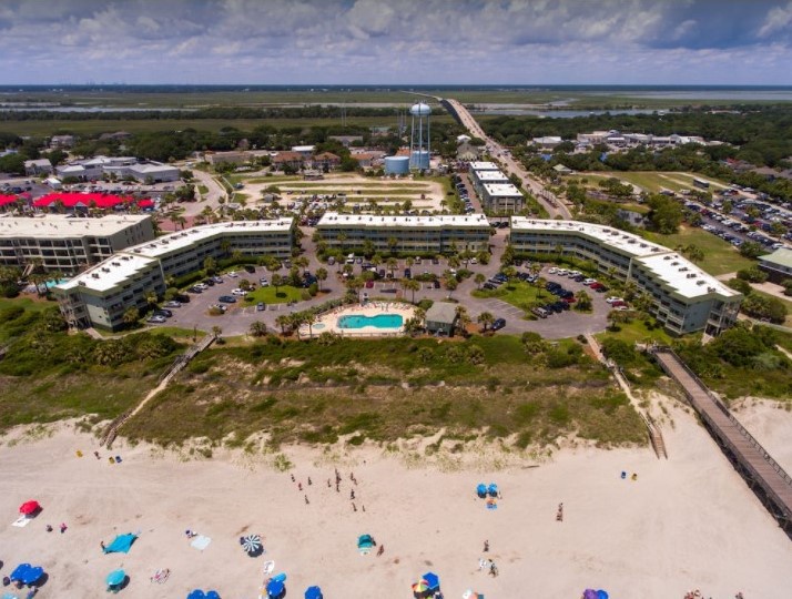 Beachfront property with direct beach access, swimming pool, and coastal town setting.