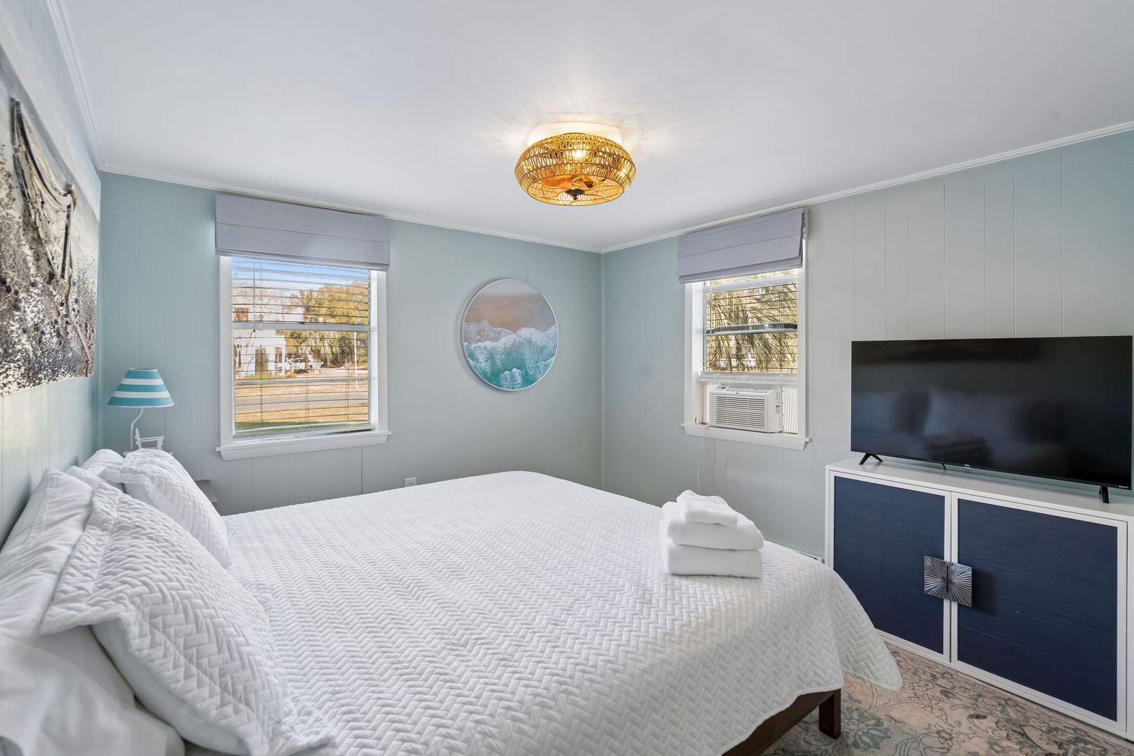 Drift off in this serene coastal bedroom with soft mint walls, crisp linens, and ocean-inspired decor that creates your peaceful retreat.