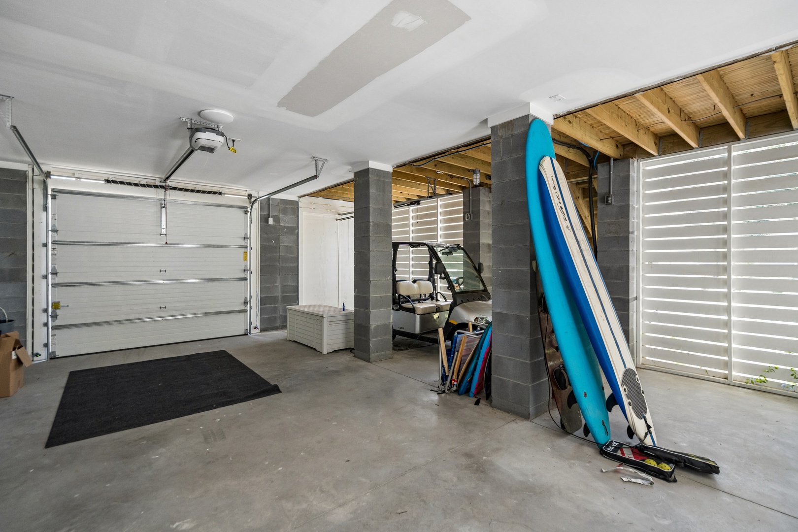 Spacious garage with convenient storage and room for your gear—beach equipment and outdoor essentials stay neatly organized and ready for your next adventure.