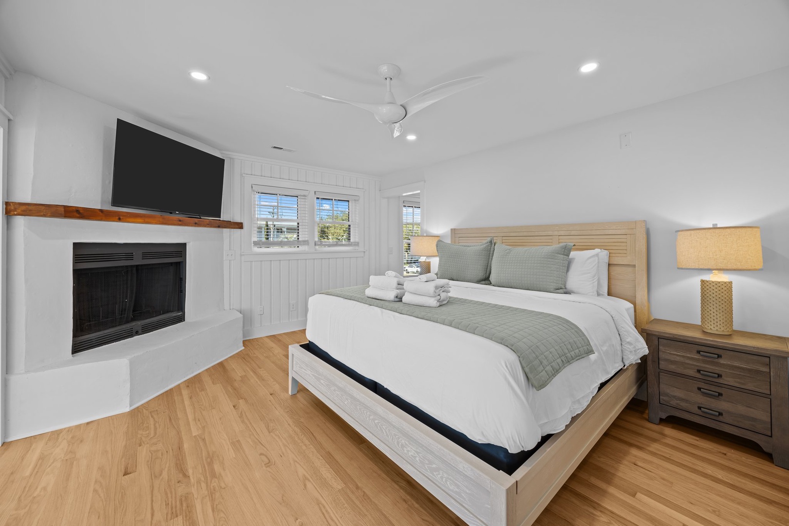 Unwind in your serene bedroom with cozy fireplace, flat-screen TV, and crisp linens awaiting your peaceful night's rest.