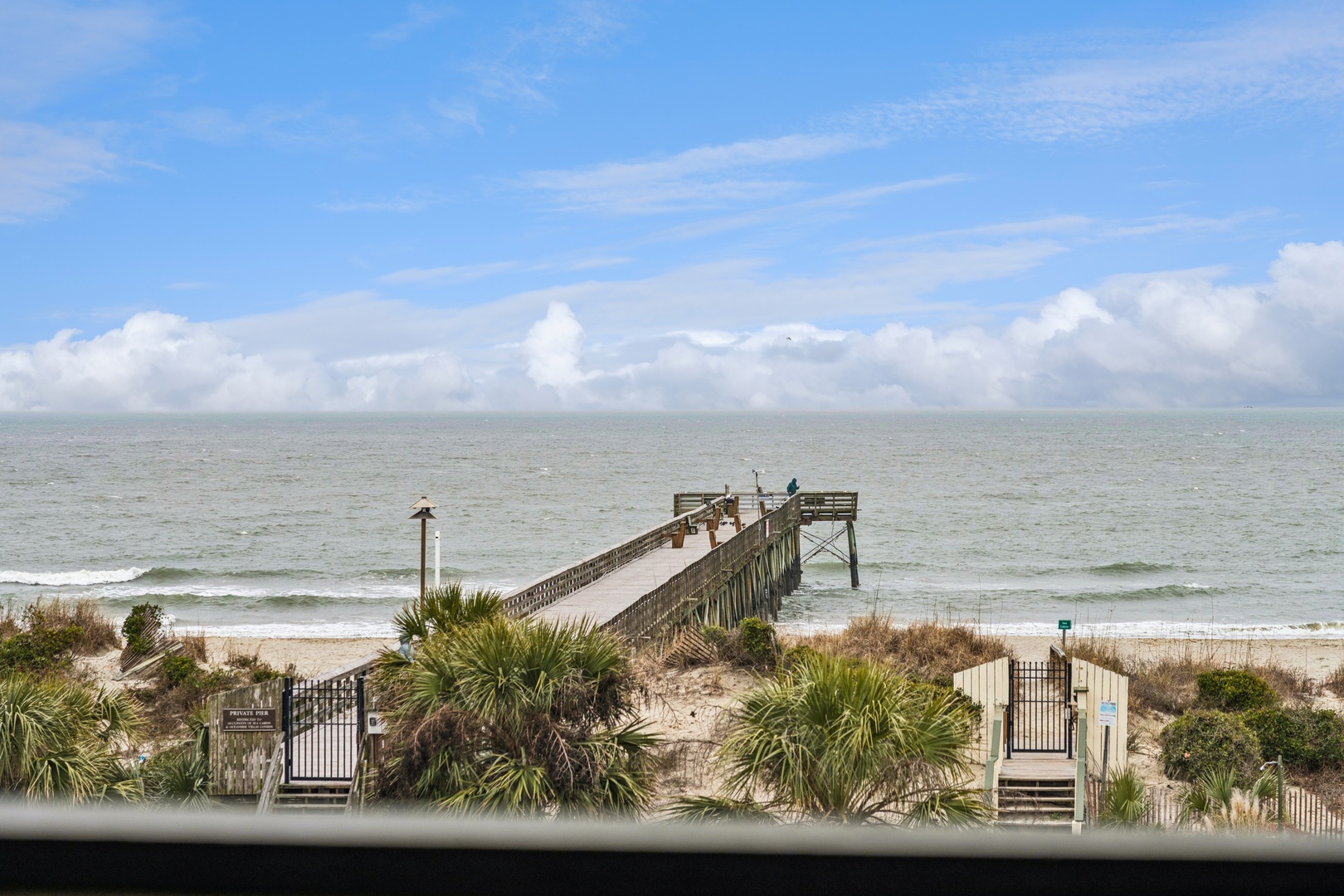 Stunning oceanfront view with private beach access and fishing pier just steps from your door.