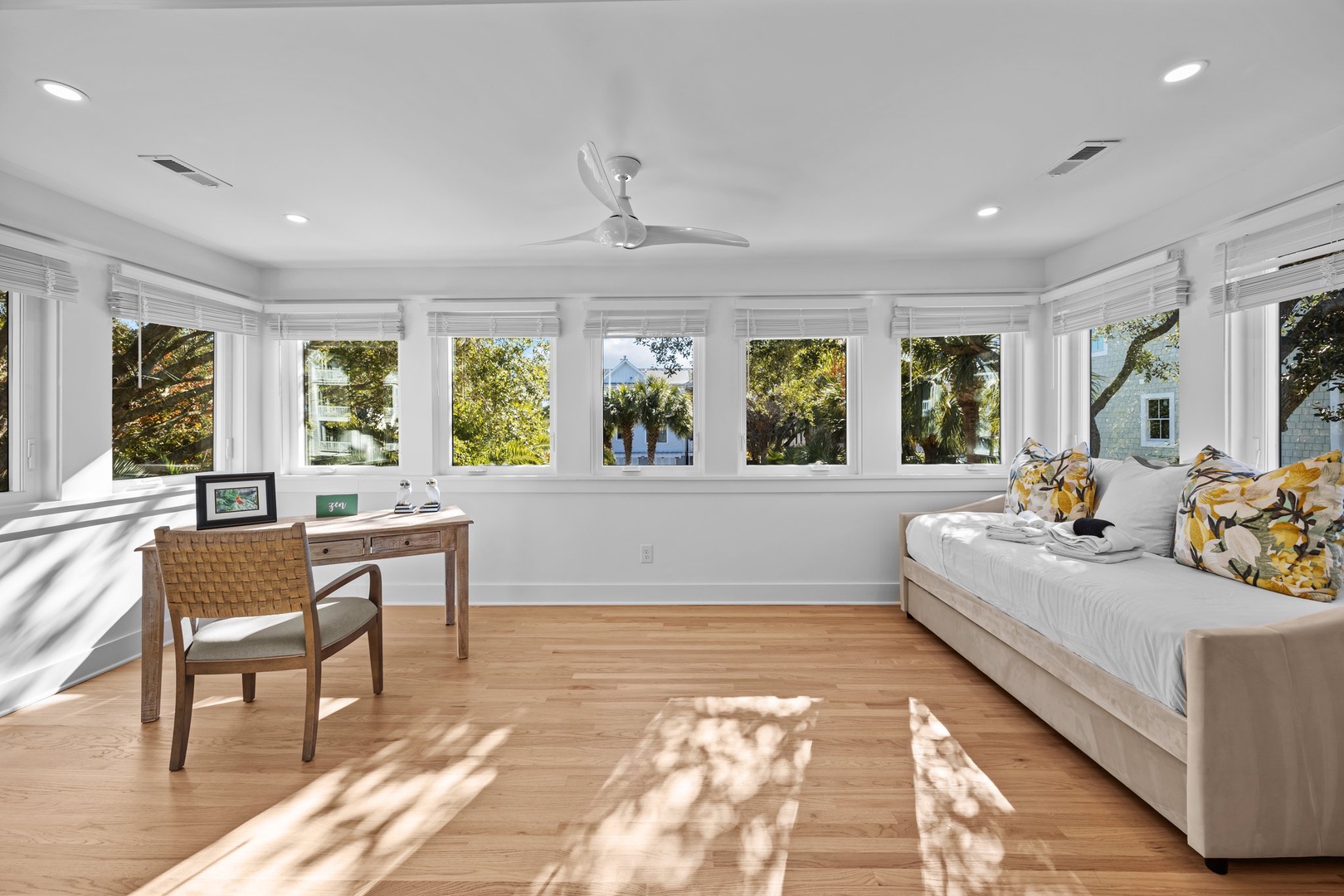 Sunlight streams through expansive windows, warming your private workspace where you'll write postcards home surrounded by tropical garden views.