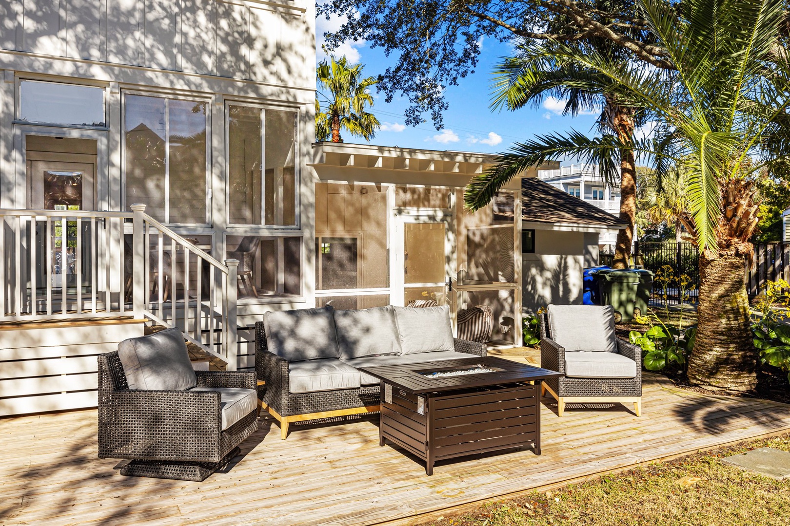 Unwind in your private outdoor lounge, where comfortable seating and tropical palms create the perfect spot for morning coffee or evening relaxation.