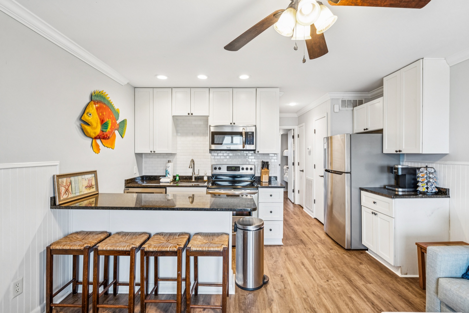 Your fully equipped kitchen features granite counters, breakfast bar seating, and all appliances for preparing meals during your stay.