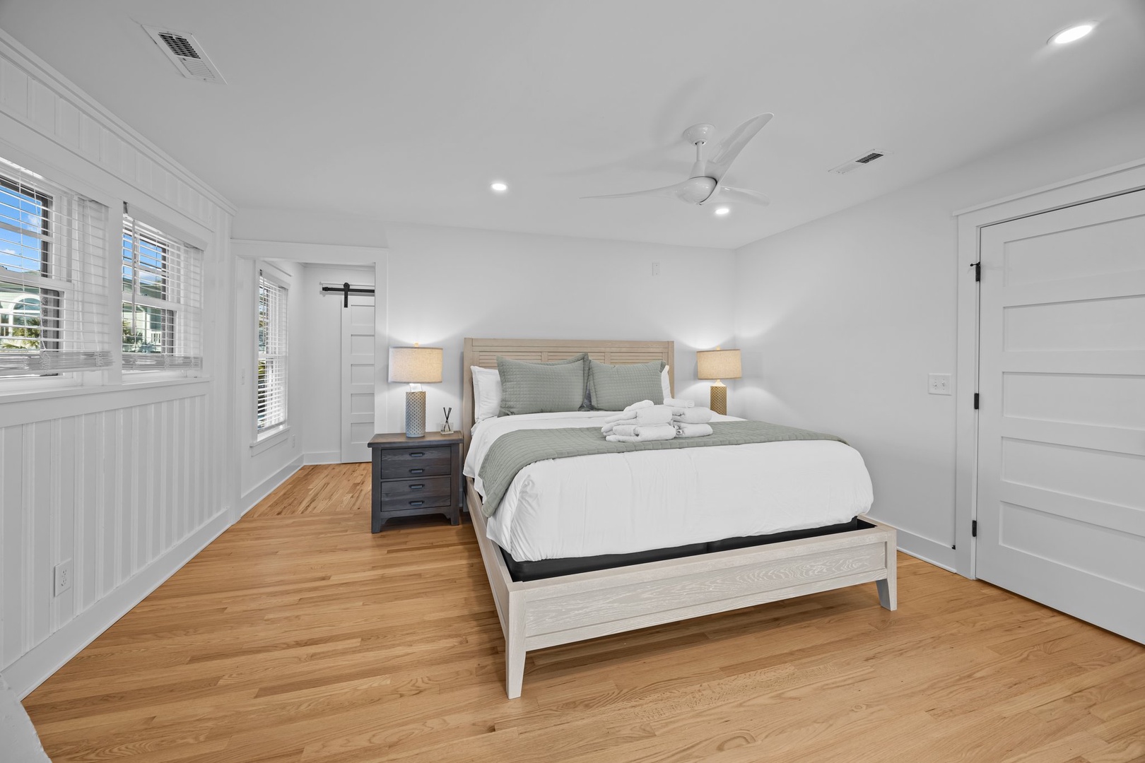 Drift off to sleep in your serene bedroom with crisp linens, warm wood floors, and soft lighting creating the perfect retreat.