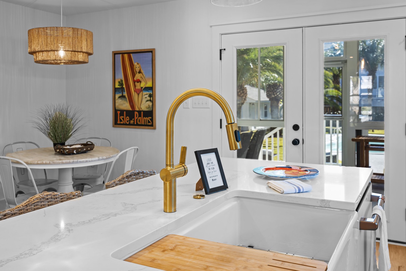 Your modern kitchen features gleaming marble countertops and a striking gold faucet, perfect for preparing meals with style.