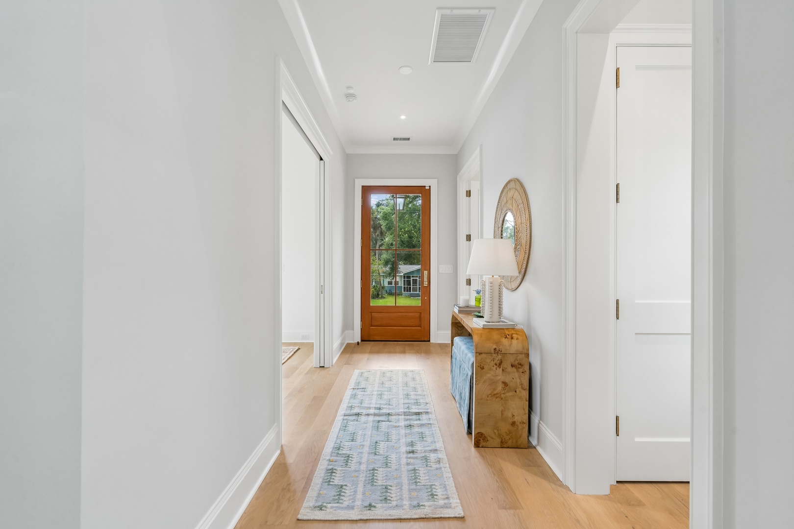 Step into your bright, welcoming hallway where coastal-inspired accents and warm wood tones guide you through this peaceful retreat.