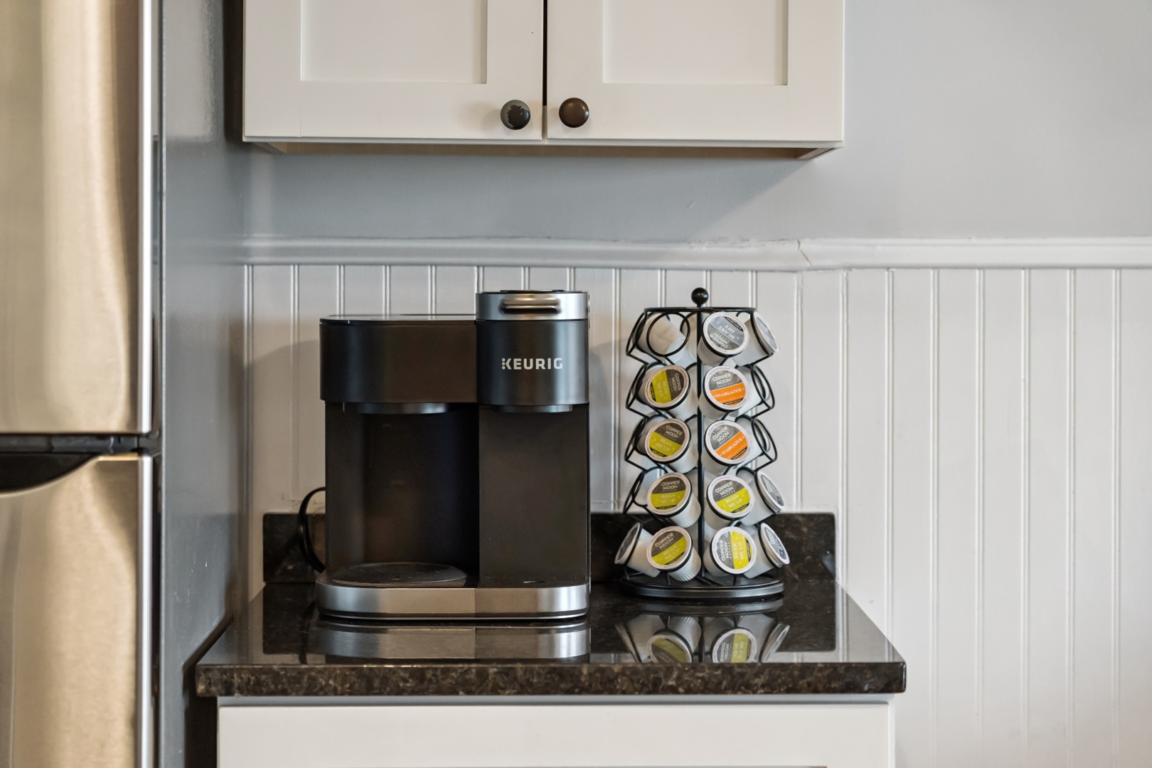 Start your mornings with fresh coffee from your personal Keurig machine and selection of K-cups in this bright, well-appointed kitchen.
