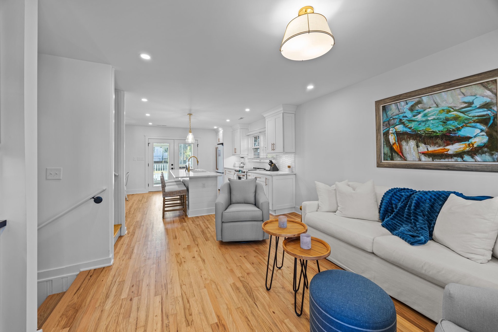 Sink into the plush sofa and admire coastal art while the open kitchen awaits your culinary adventures.