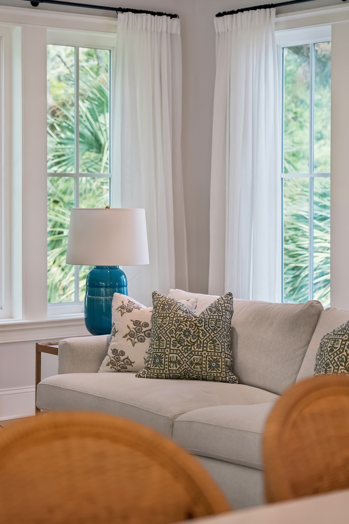 Sink into this elegant sofa as natural light spills through your windows, framing lush tropical greenery. Thoughtful touches and breezy views create a serene retreat for unwinding after your adventures.