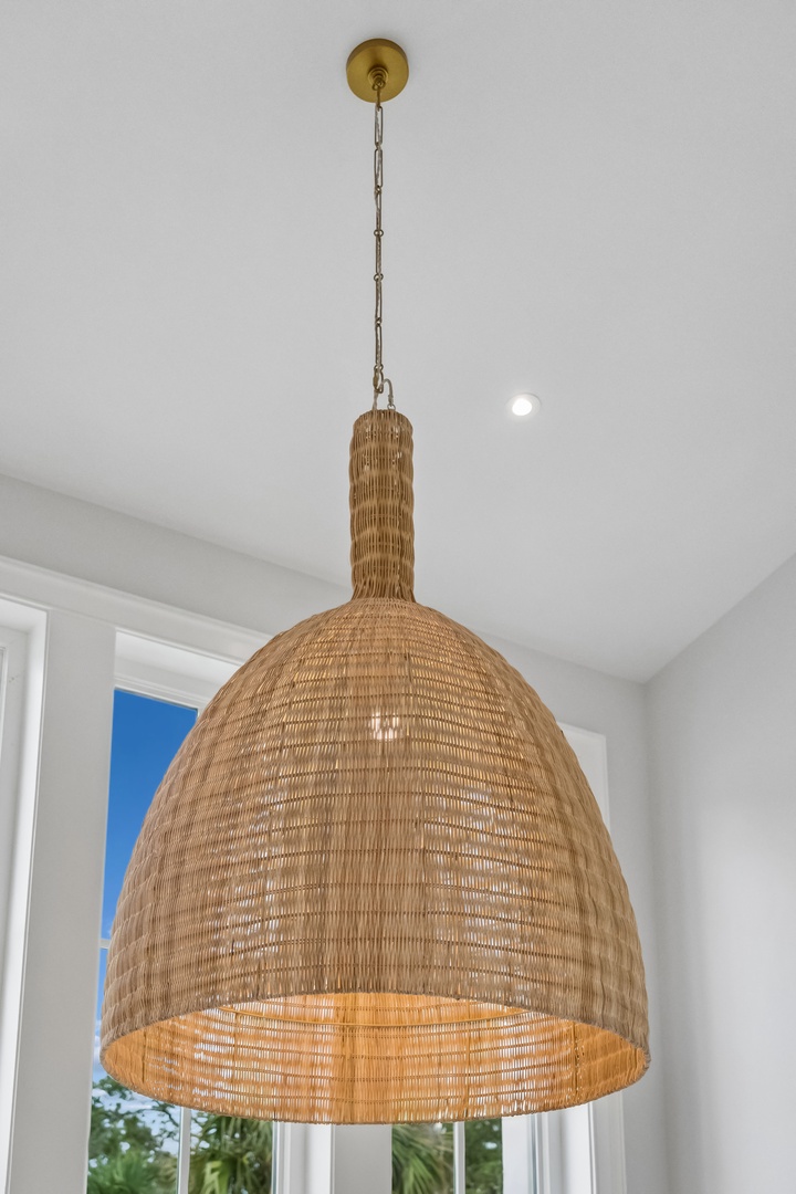 A handwoven rattan pendant light adds natural warmth and coastal charm to your space. The textured shade casts a soft, inviting glow perfect for relaxed evenings.