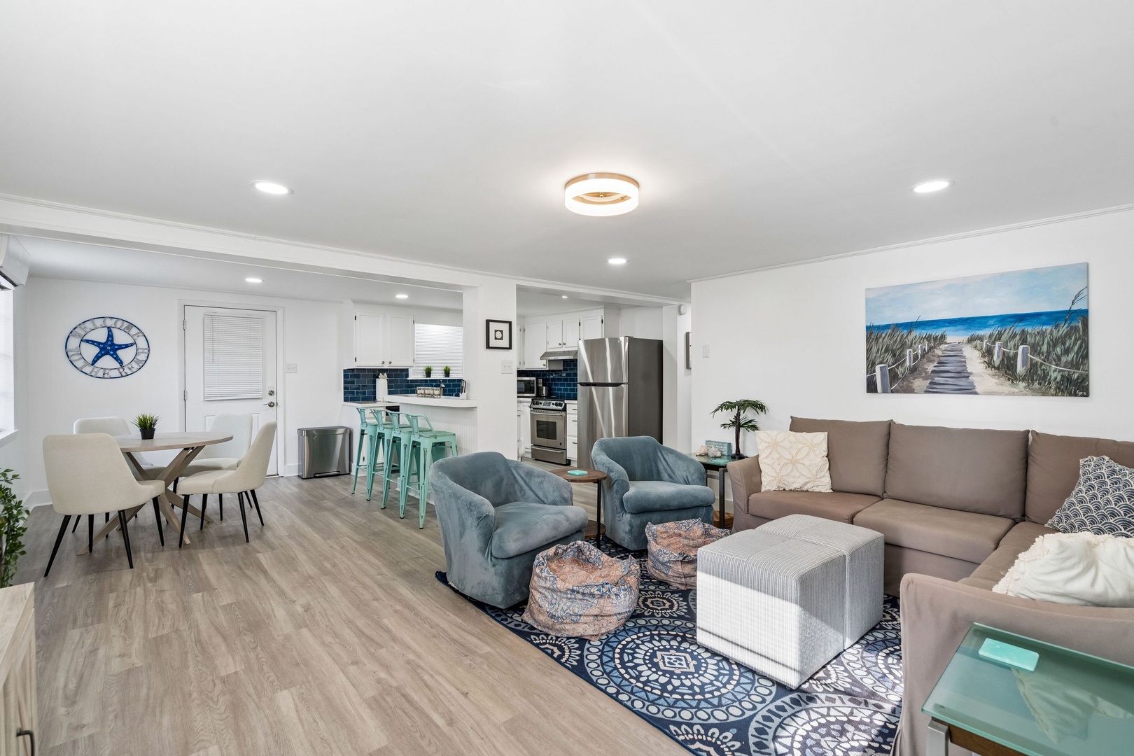 Relax in your bright open-plan living space where coastal charm meets modern comfort—perfect for unwinding after beach days.