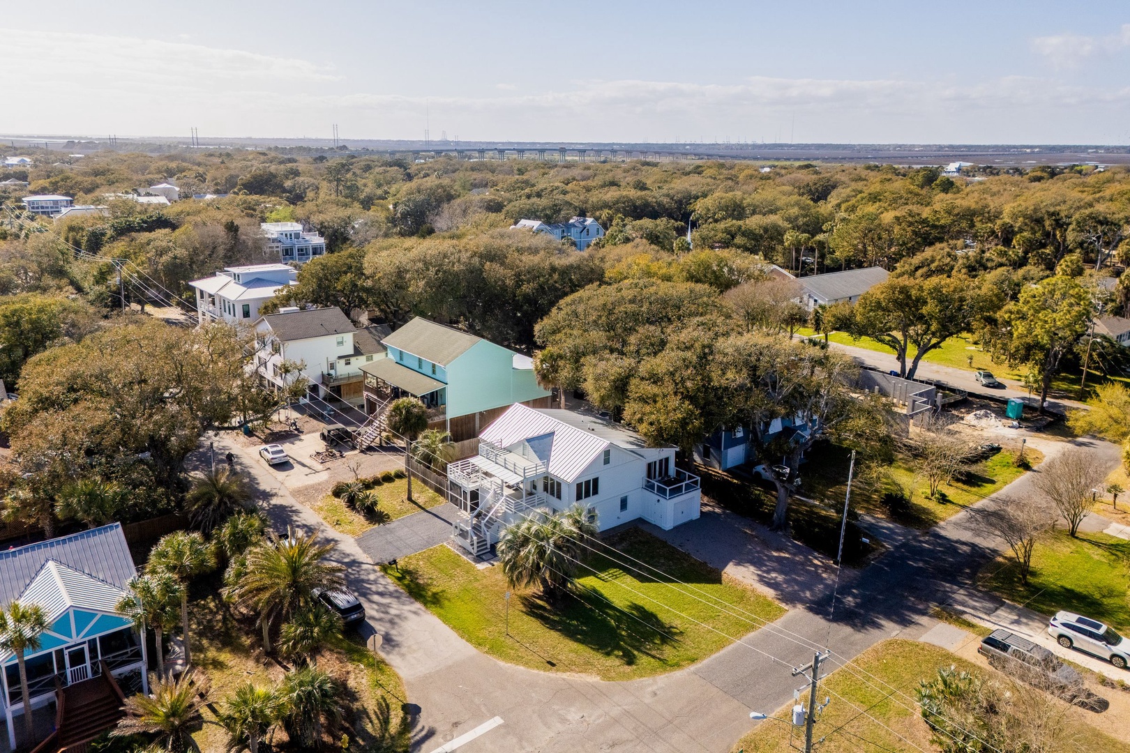 Aerial view showcasing the property's prime location within a tree-lined residential neighborhood, offering peaceful surroundings and convenient street access.