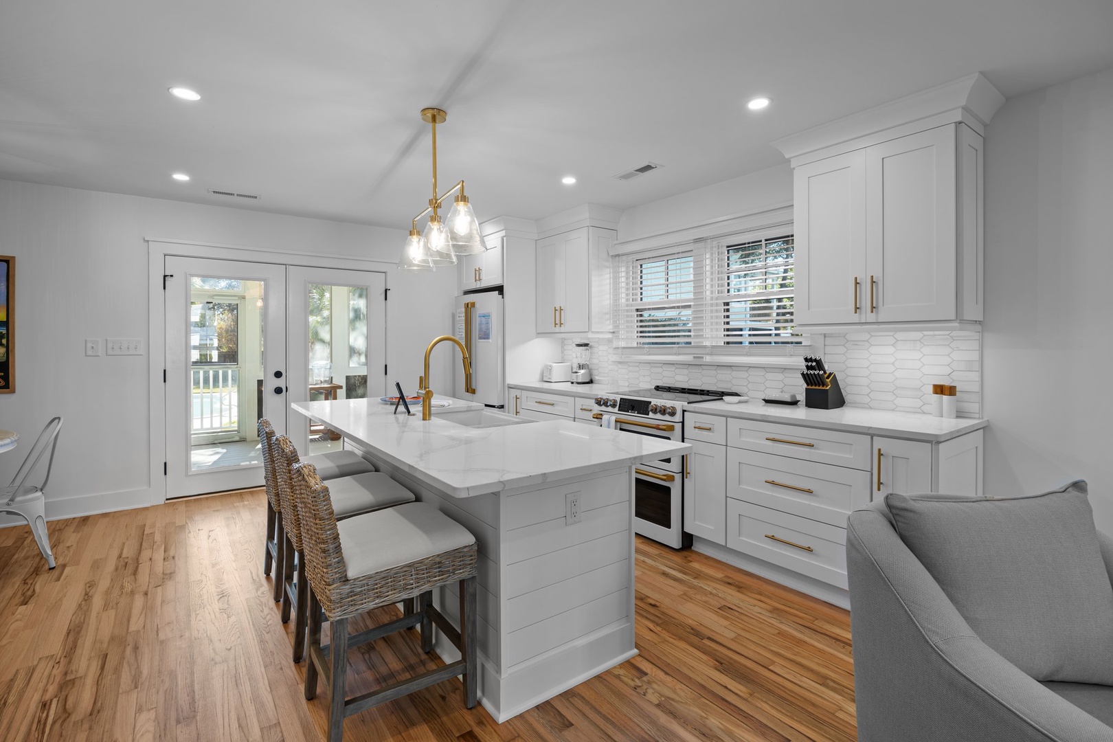 Your modern kitchen features white cabinetry, quartz countertops, and a breakfast island where you'll love preparing meals and enjoying morning coffee.