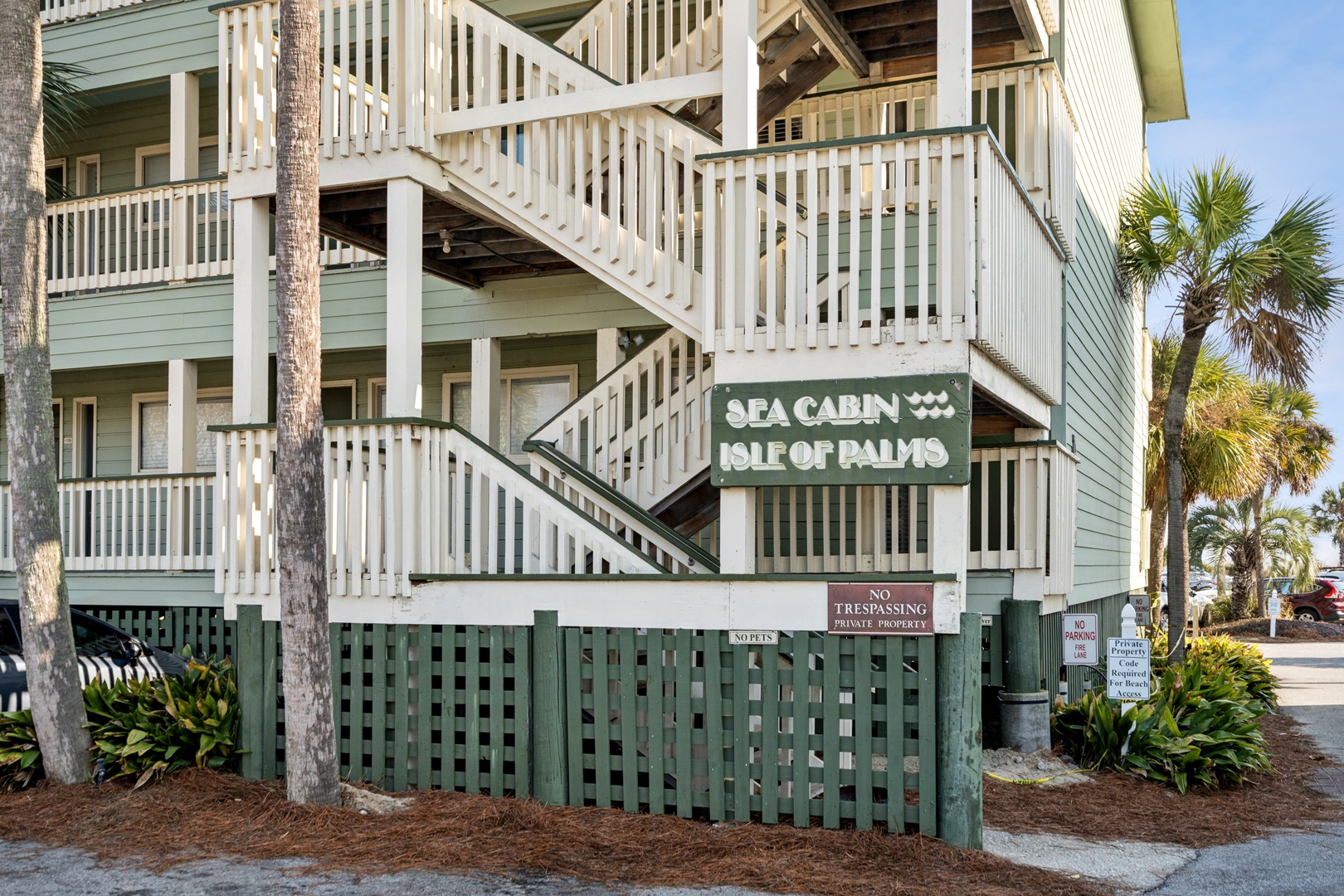 A charming coastal property with palm trees and elevated walkways, creating the perfect beachside retreat atmosphere.