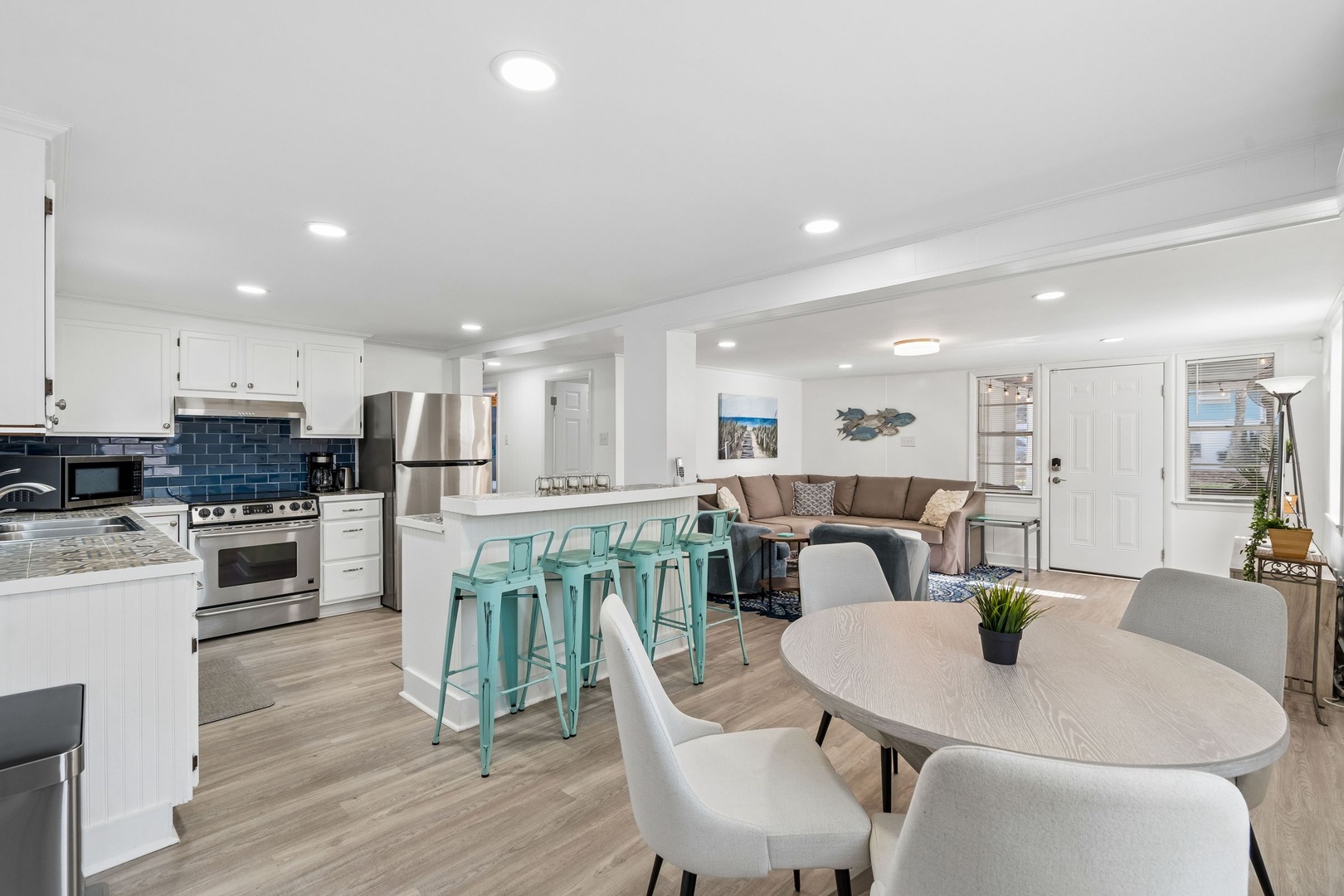 Your bright open-concept space flows seamlessly from kitchen to living area, where modern design meets coastal charm for memorable gatherings.