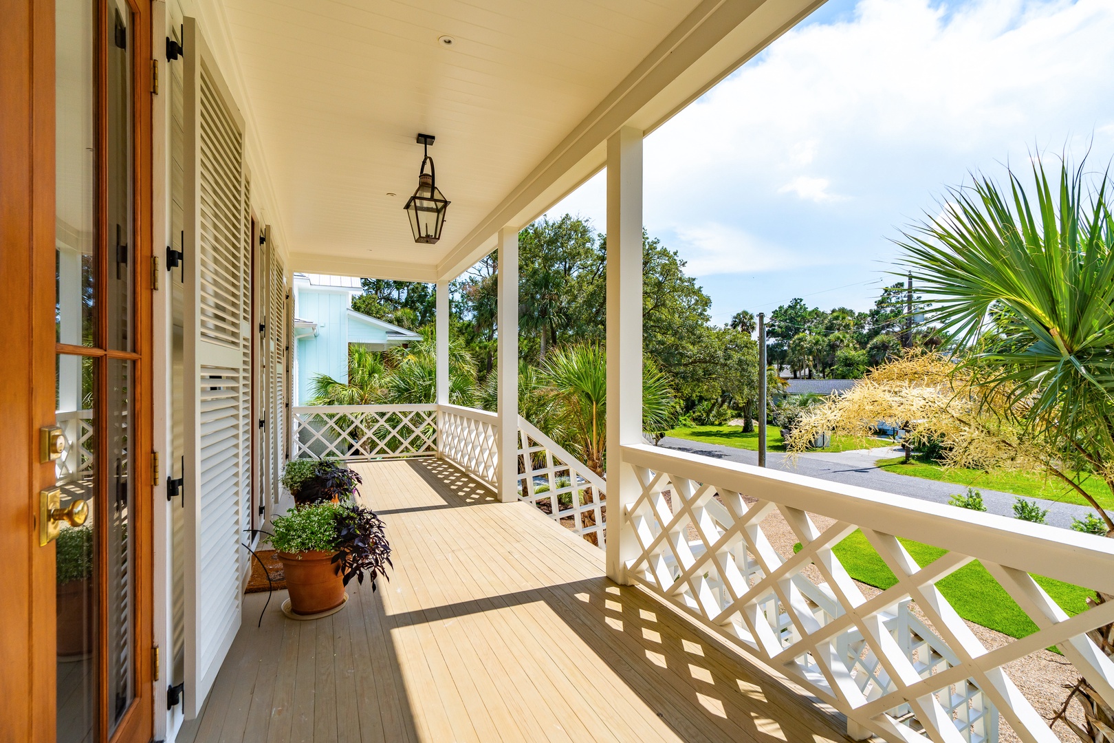 Step out onto your covered porch and take in the lush, tropical surroundings of this charming coastal neighborhood. Relax on the shaded deck with a morning coffee as sunlight filters through the palms.