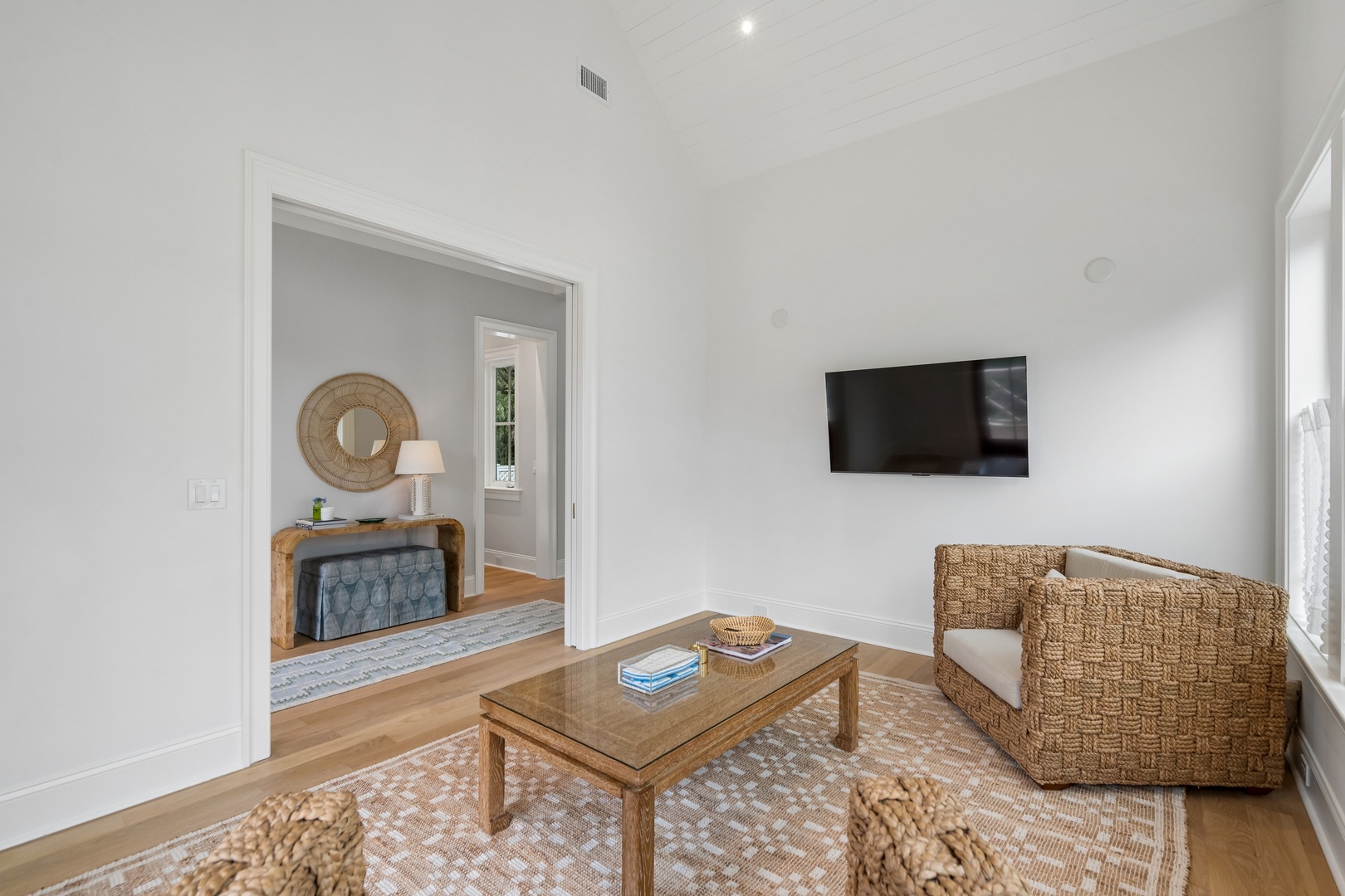 Relax in your bright, airy living space featuring natural wood furnishings and coastal-inspired décor. Vaulted ceilings and plenty of light create an open, inviting retreat for unwinding after exploring the area.