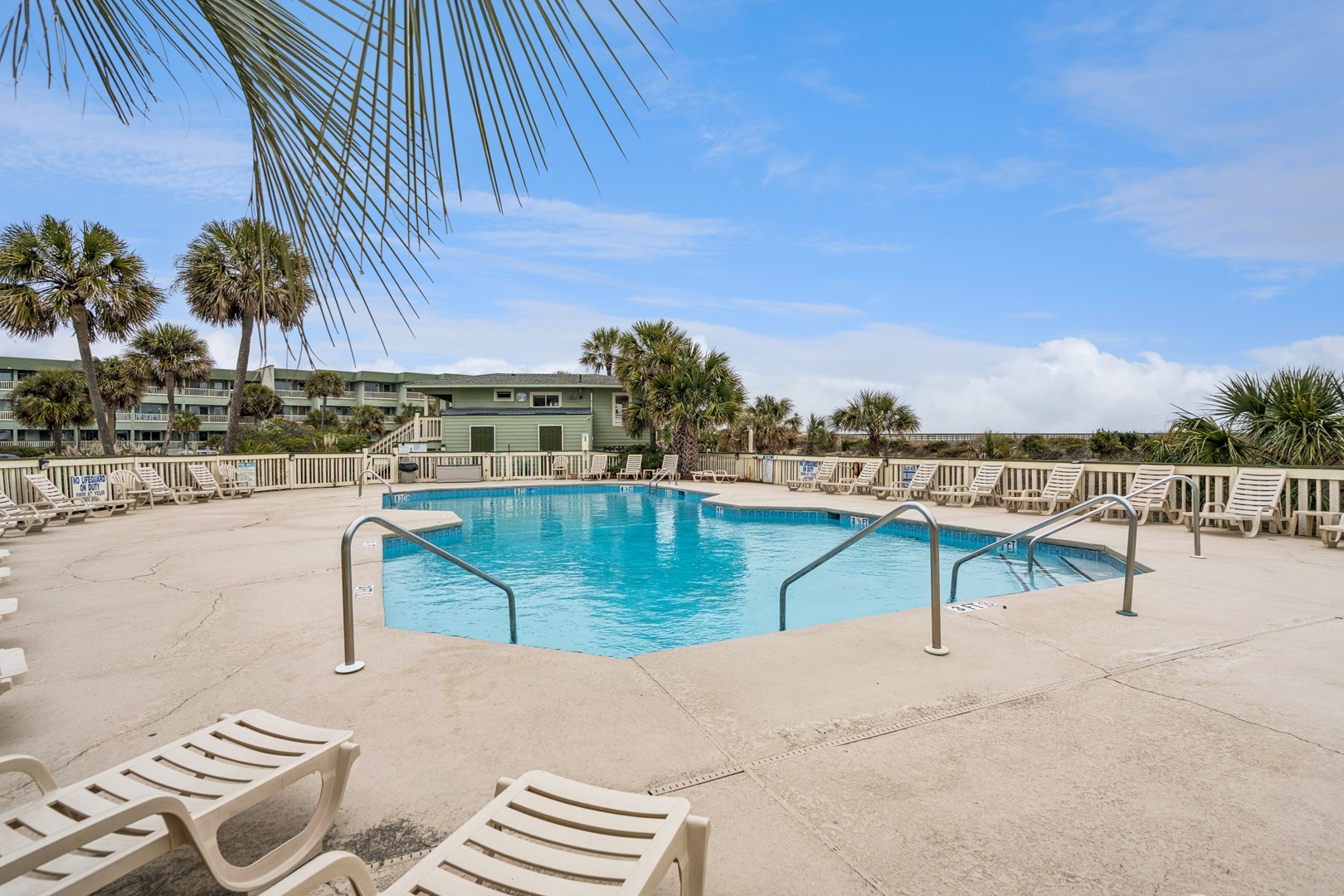 Dive into tropical bliss at your private pool oasis, surrounded by swaying palms and comfortable loungers for perfect relaxation.