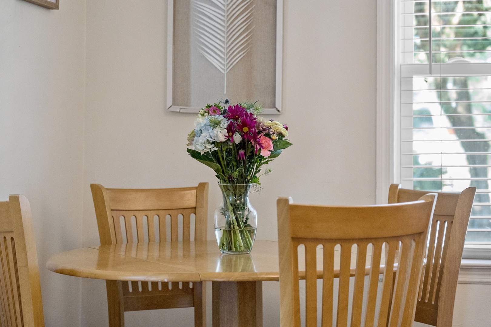 Gather around this welcoming dining space where fresh flowers add warmth to your meals together.