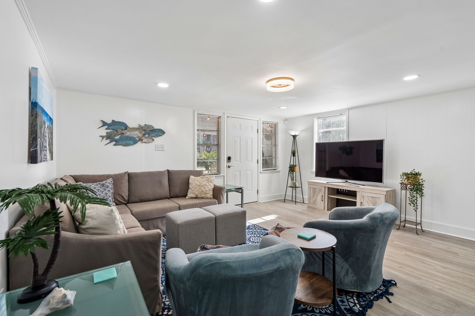 Sink into the plush sectional and unwind in your bright, coastal-inspired living space with modern amenities and stylish touches.