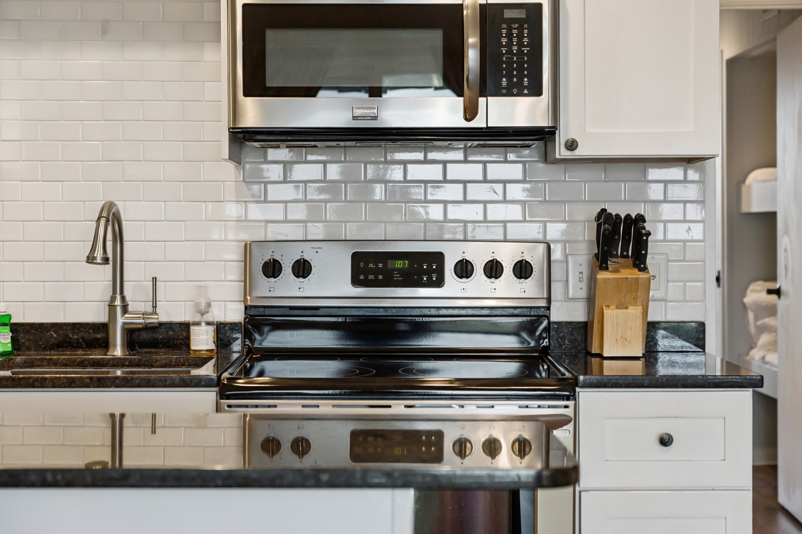 Your fully equipped kitchen features modern appliances and elegant subway tile backsplash, perfect for preparing your favorite meals.