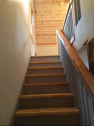 The charming staircase connects the main living spaces with the upstairs bedrooms,  providing easy access throughout the home.