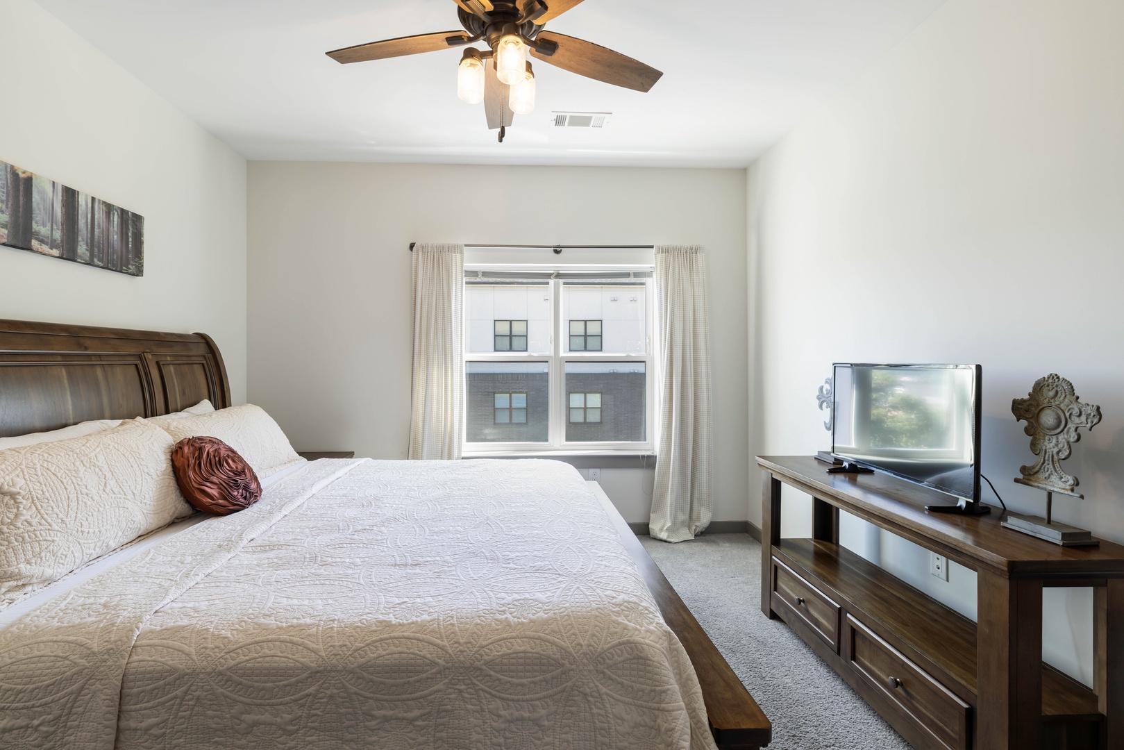 The large window fills the bedroom with beautiful natural light, creating a bright and welcoming space to start and end your day.