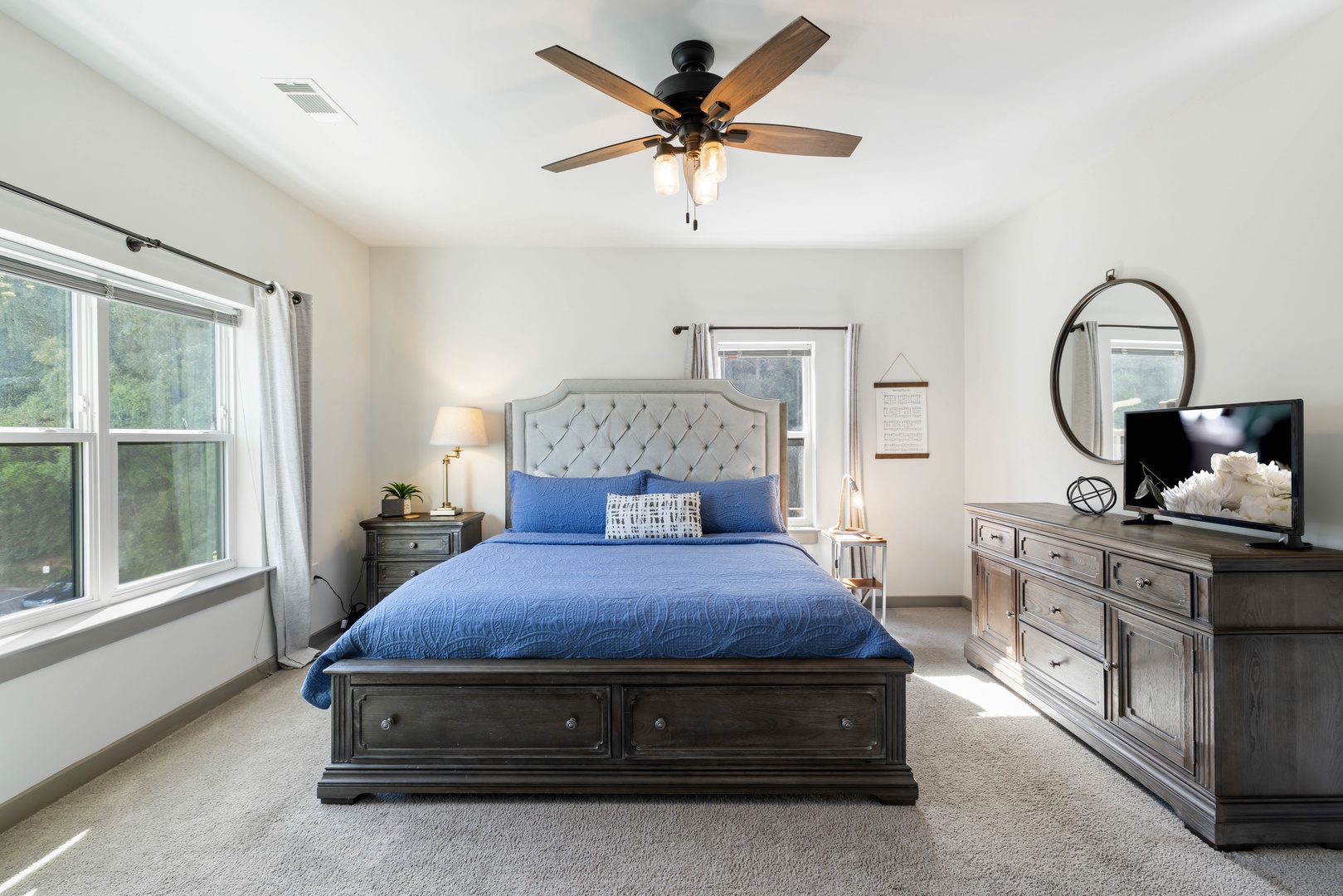 Unwind in the comfortable master bedroom featuring a luxurious king bed and a peaceful atmosphere.