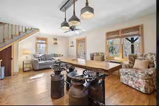 Step into this bright, open living area where wood floors, comfy seating, and large windows create a warm, welcoming space for you to unwind and reconnect.