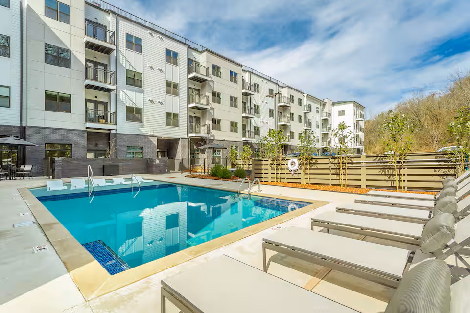 The pool area offers ample seating around the deck, making it easy to relax, sunbathe, or spend time with your group.