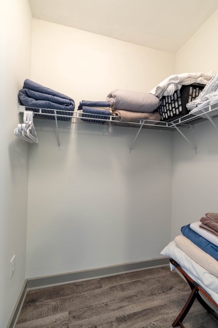 Enjoy the convenience of the attached walk in closet with plenty of space to unpack and store your belongings, plus additional linens available for your comfort during your stay.