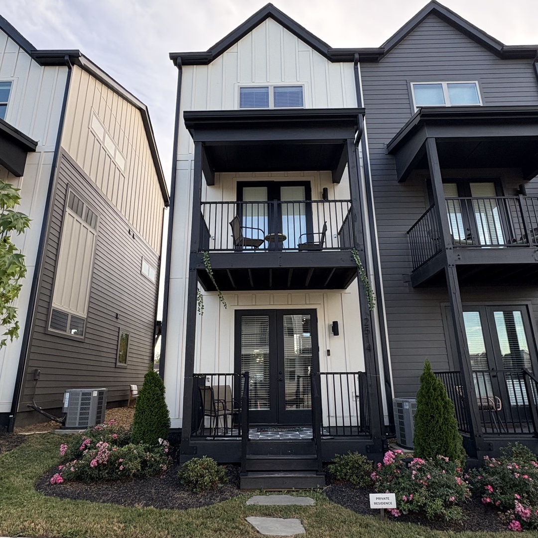 Back of homes extirior with porch and balcony