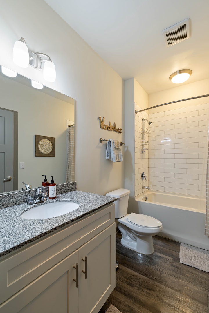 Enjoy the convenience of a full tub and shower combo, perfect for a refreshing morning routine or a relaxing soak after a day of exploring.