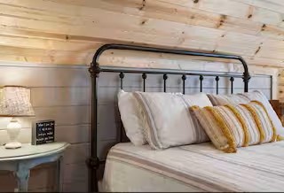 Enjoy the privacy and peaceful ambiance of the upstairs primary bedroom, thoughtfully designed as a cozy escape where you can unwind, recharge, and fully embrace the charm of your cabin getaway.