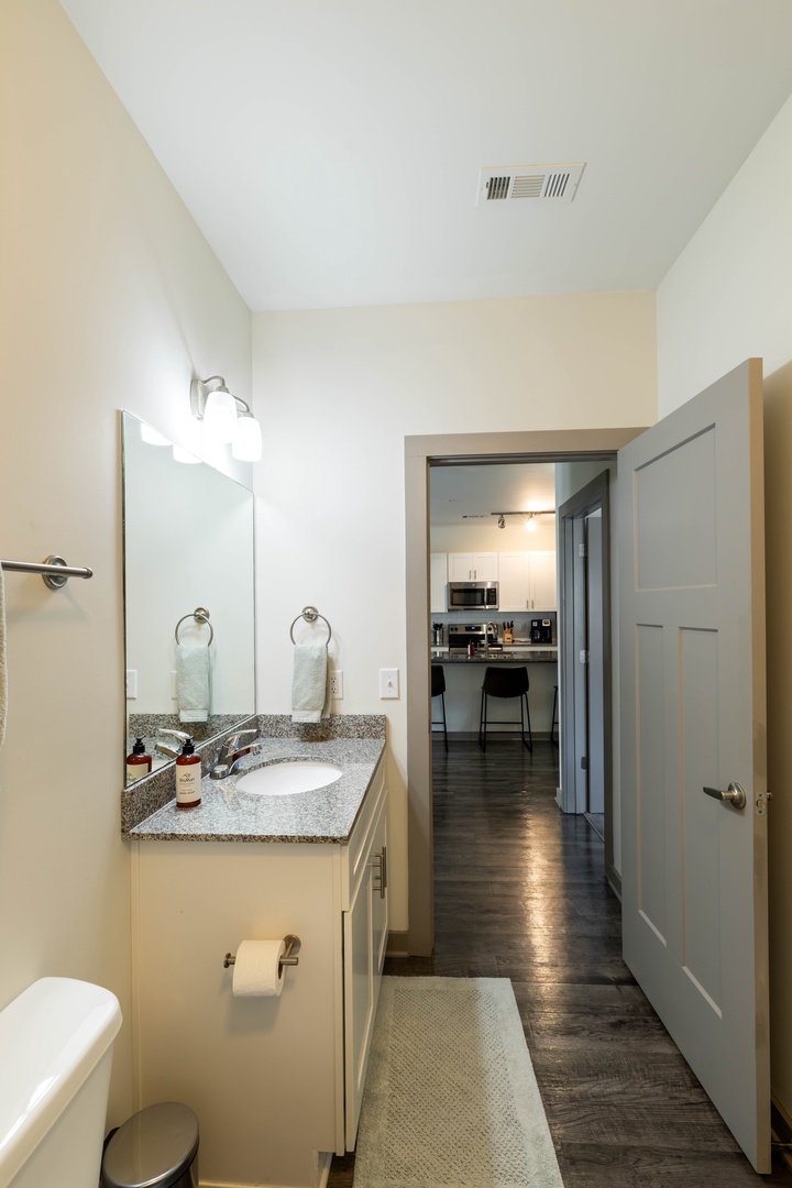 The single sink vanity offers a convenient space to get ready, complete with a hair dryer and room for your daily essentials.