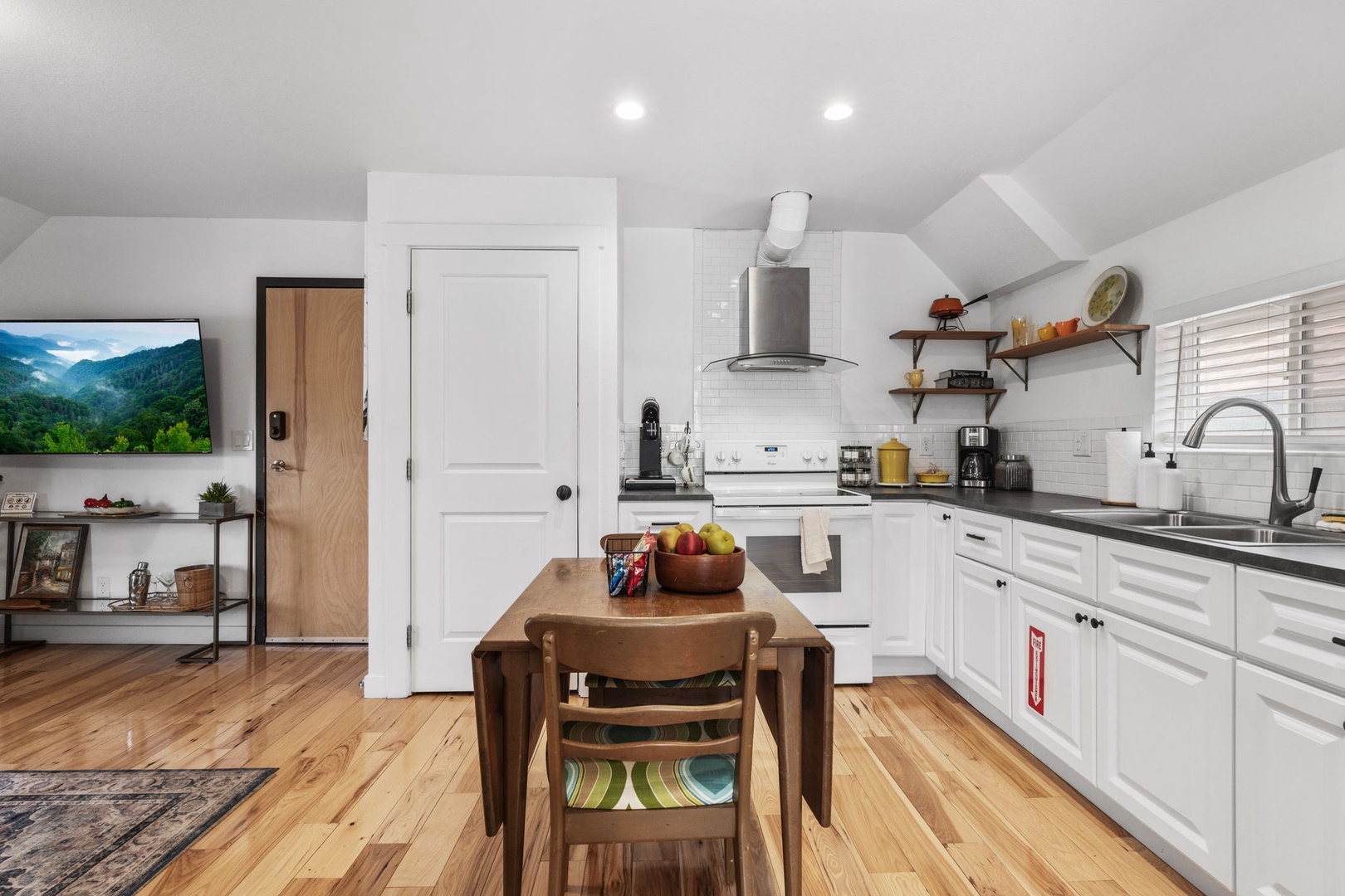 Your bright kitchen features white cabinets, granite counters, and a cozy dining nook—perfect for morning coffee and home-cooked meals.