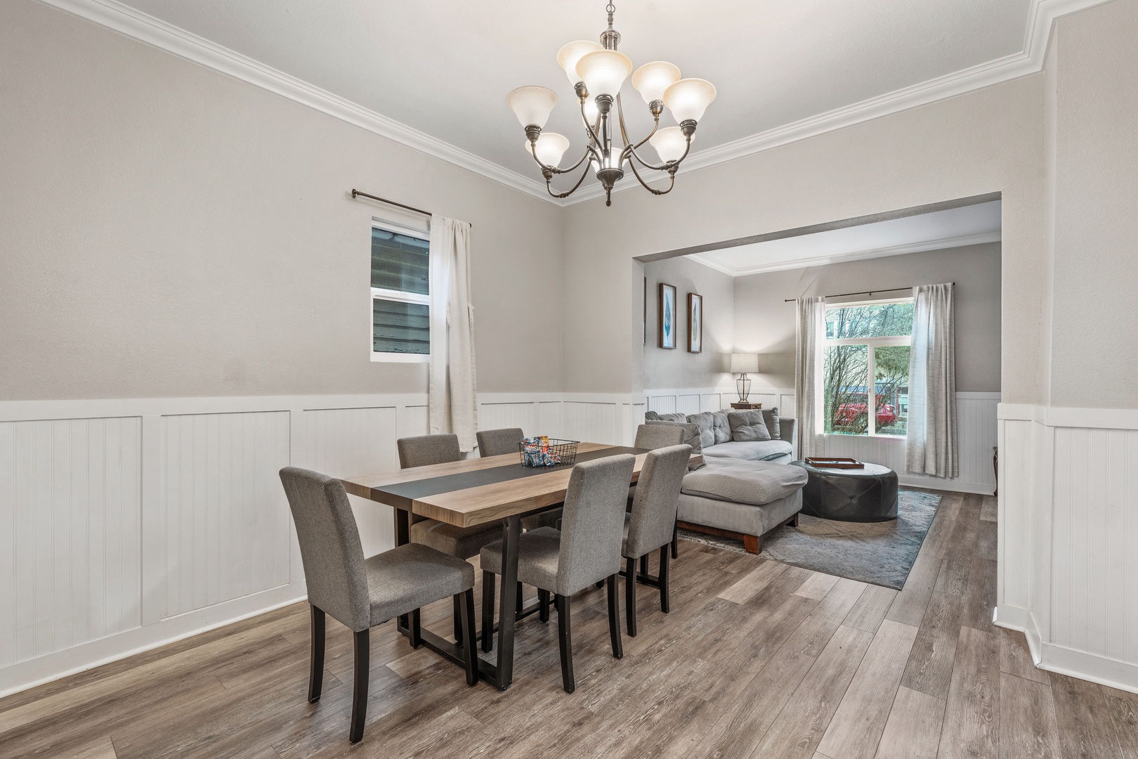 Your elegant dining space flows seamlessly into a cozy living area, featuring beautiful hardwood floors and sophisticated decor for memorable meals together.
