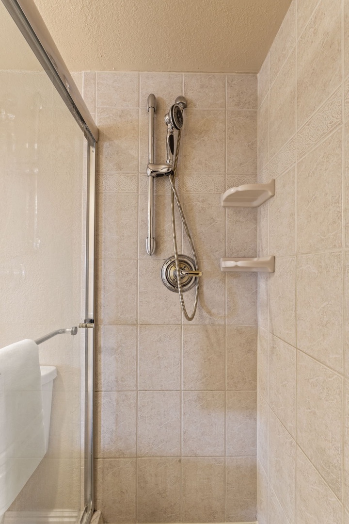 Step into your private tiled shower with handheld spray and built-in shelves for your toiletries—refreshing simplicity awaits after each adventure.