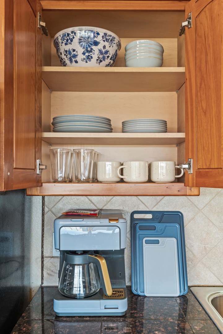 Everything you need for your morning coffee is neatly organized and ready—just open up and brew. Plates, bowls, mugs, and glassware arranged within easy reach to start your day comfortably.