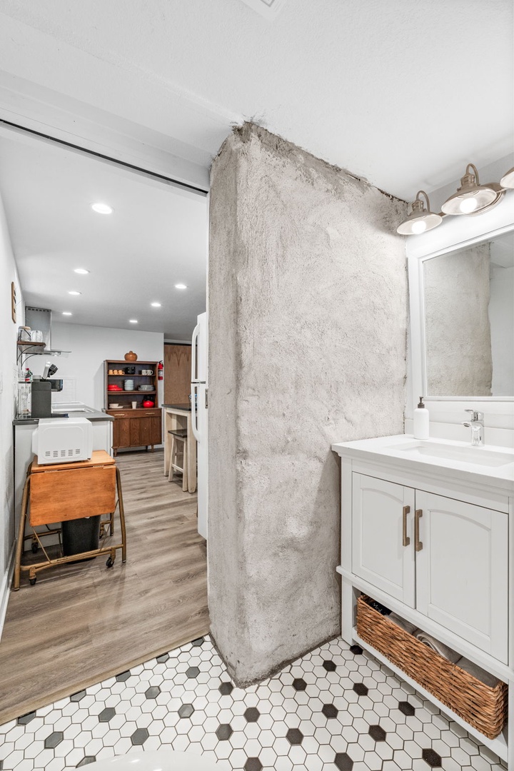 Your stylish bathroom flows seamlessly into the modern kitchen, creating an open-concept space perfect for getting ready.
