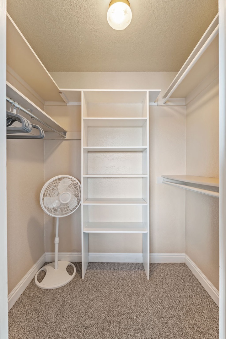 Your personal walk-in closet features custom shelving, dual hanging rods, and ample storage space to keep your vacation wardrobe perfectly organized and easily accessible.