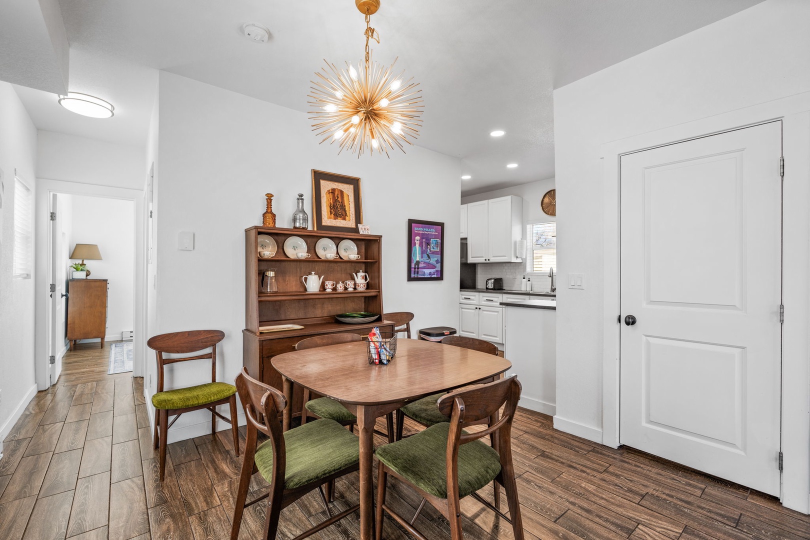 Gather around your stylish dining table beneath the stunning starburst chandelier for memorable meals and conversations in this thoughtfully designed space.